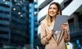 Portrait of a successful business woman using digital tablet in front of modern business building Royalty Free Stock Photo