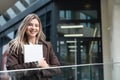 Portrait of a successful business woman using digital tablet in front of modern business office building. Professional female, Royalty Free Stock Photo