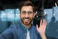 Portrait of successful businessman in casual shirt and glasses man looking at smartphone camera and smiling, camera view Royalty Free Stock Photo