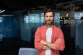 Portrait of successful businessman owner of small business, mature man in casual red shirt standing smiling and looking Royalty Free Stock Photo