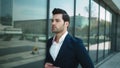 Portrait businessman walking in suit. Man checking time on wrist watch outside Royalty Free Stock Photo