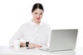 Portrait of successful calm attractive brunette businesswoman with makeup in white shirt sitting with laptop and looking at camera Royalty Free Stock Photo