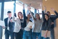 Portrait of successful creative business team looking at camera and celebrating. Diverse business people standing together at Royalty Free Stock Photo