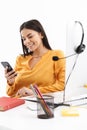 Portrait of successful customer supporter woman holding smartphone while working in call center