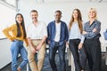 Portrait of successful diverse business people standing together at startup office. Royalty Free Stock Photo