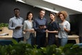 Portrait of successful diverse employees team holding electronic devices