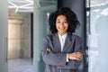 Portrait of successful female boss in business suit, mature African American woman smiling and looking at camera with Royalty Free Stock Photo