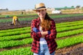 Portrait of successful female farmer in backyard of farm