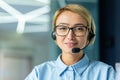 Portrait of successful female online customer support worker, close-up businesswoman smiling and looking at camera Royalty Free Stock Photo