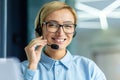 Portrait of successful female online customer support worker, close-up businesswoman smiling and looking at camera Royalty Free Stock Photo
