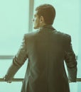 Portrait of a successful handsome businessman in front of a window, there is an empty space for text Royalty Free Stock Photo