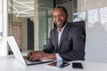 Portrait of successful happy african american boss, man smiling and looking at camera, businessman in business suit Royalty Free Stock Photo