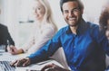 Portrait of successful hispanic businessman smiling on the business meeting with partners in modern office.Horizontal