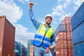 Portrait of successful logistic staff worker raising hand up in the air. success and enjoy work concepts