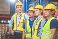 Portrait of successful logistics warehouse workers team, Group portrait of industry workers, Workers in hardhat helmet at