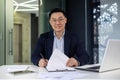 Portrait of successful mature adult boss, asian businessman experienced smiling, looking at camera, man signing document Royalty Free Stock Photo