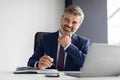 Successful Mature Businessman Wearing Suit Sitting At Desk With Laptop In Office Royalty Free Stock Photo