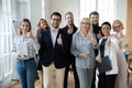 Portrait of successful mature businesswoman and team showing thumbs up Royalty Free Stock Photo