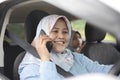 Muslim Lady Smiling and Talking on Phone in Her Car Royalty Free Stock Photo
