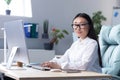 Portrait of successful office worker Asian woman, looking at camera smiling, business woman in glasses working and Royalty Free Stock Photo