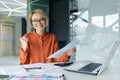 Portrait of successful and satisfied female financier at workplace inside office, businesswoman smiling, looking at Royalty Free Stock Photo