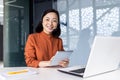 Portrait of successful satisfied female online customer service support worker, Asian business woman looking at camera Royalty Free Stock Photo