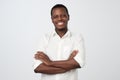 Portrait of successful serious handsome afroamerican man in shirt crossed hands and smiling