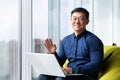 Portrait of successful smiling asian man inside office, man smiling and looking at camera near window, businessman Royalty Free Stock Photo