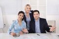 Portrait: successful smiling business team of three people; man