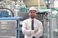 Portrait of a successful smiling businessman/ engineer on site in an industrial factory with helmet Royalty Free Stock Photo