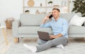 Portrait of successful smiling man using phone and laptop Royalty Free Stock Photo