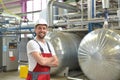 Portrait of successful smiling workers/ engineers on site in an industrial factory with helmet