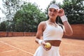 Successful sportswoman with yellow ball at the tennis court