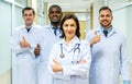 Portrait of successful team of medical doctors are looking at camera and smiling while standing in hospital Royalty Free Stock Photo