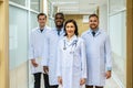 Portrait of successful team of medical doctors are looking at camera and smiling while standing in hospital Royalty Free Stock Photo