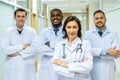 Portrait of successful team of medical doctors are looking at camera and smiling while standing in hospital Royalty Free Stock Photo