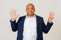 Portrait of successful young African American businessman guy, showing with fingers to number eight, smiling, confident and happy Royalty Free Stock Photo