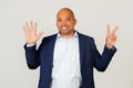 Portrait of successful young African American businessman guy, showing with fingers to number seven, smiling, confident and happy Royalty Free Stock Photo