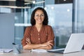 Portrait of successful young businesswoman, Hispanic woman working inside modern office building smiling and looking at Royalty Free Stock Photo