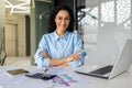 Portrait of successful young businesswoman, Hispanic woman working inside modern office building smiling and looking at Royalty Free Stock Photo