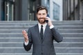 Portrait successful young confident businessman talking background urban modern office building in downtown Bearded business man Royalty Free Stock Photo