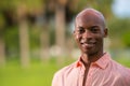 Portrait successful young African American businessman in a pink shirt unbuttoned