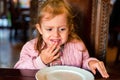 Unhappy preschooler girl doesn`t want to eat