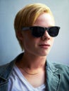 Portrait, sunglasses and a cool young boy in studio on a gray background for trendy youth style. Fashion, face and Royalty Free Stock Photo