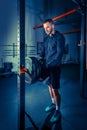 Portrait of super fit muscular young man working out in gym with barbell Royalty Free Stock Photo