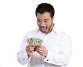 Portrait, super happy excited successful young man holding money dollar bills in hand