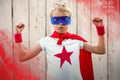 Composite image of portrait of superhero boy with arms raised