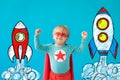 Portrait of superhero child against blue background