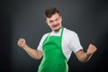 Portrait supermarket employer holding fists looking happy