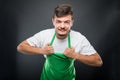 Portrait supermarket employer holding his apron